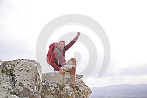 Happiness, mountain and man with celebration for hiking, peak and journey with success and freedom outdoor. Trekking