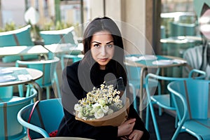 Happiness, romance and beauty concept. Cheerful gorgeous brunette young woman holding bouquet of flowers and smiling.