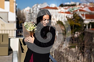 Happiness, romance and beauty concept. Cheerful gorgeous brunette young woman holding bouquet of flowers and smiling.