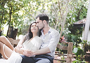 Happiness and romantic scene of love asian couples partners making eye contact in the garden.