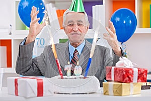 Happiness senior man celebrating 70th birthday