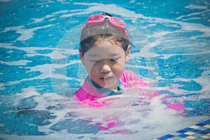 Happiness and Smiling Asian cute little girl has feeling funny and enjoy in swimming pool.