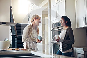 Happiness is time spent with your best friend. two young women having coffee together on a relaxing day at home.