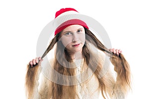 Happiness winter holidays christmas. Teenager concept - smiling young woman in red hat, scarf and over white background.