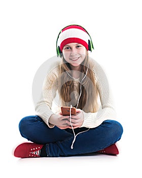 The happiness of the winter holidays Christmas. Teenager concept - smiling young woman in red hat with smartphone and