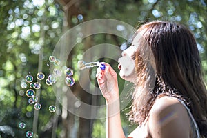 Happiness woman blowing soap joyful outdoors green park. Asian young women joy blow bubble leisure freedom lifestyle. Gorgeous