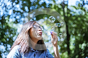 Happiness woman blowing soap joyful outdoors green park. Asian young women joy blow bubble leisure freedom lifestyle. Gorgeous