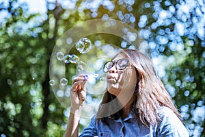 Happiness woman blowing soap joyful outdoors green park. Asian young women joy blow bubble leisure freedom lifestyle. Gorgeous