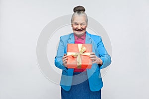 Happiness woman holding red gift box and toothy smiling