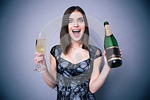 Happiness woman holding two glass and bottle of champagne