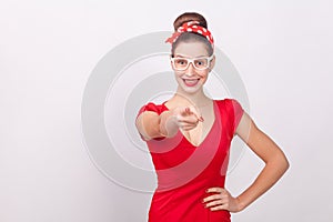 Happiness woman in red dress pointing finger an toothy smile