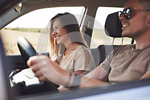 Happiness young couple traveling by car in summertime