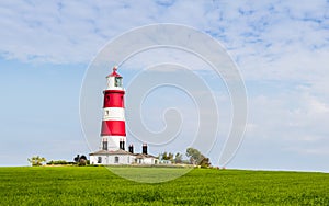 Happisburgh lighthouse under a blue sky