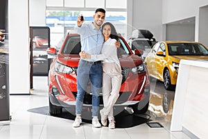 Happpy beautiful muslim family buying new car in salon