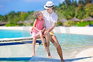Happpy father and daughter on boat during tropical