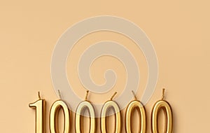 Happy 100000 celebration festive background made with golden candles in the form of number hundred thousand
