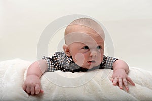 Happy 2 month old baby lifting head up