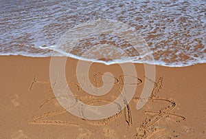 Happy 2017 lettering on the beach.