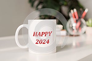 Happy 2024 inscription on mug on office background. Happy new year 2024