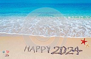 Happy 2024 written on the sand