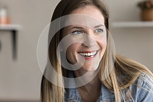 Happy 30s Caucasian woman looking away with beautiful toothy smile