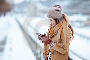 happy 40 years old woman sending text message using smartphone