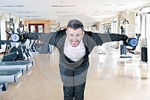 Happy 40s caucasian man exercising with weights