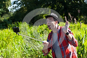 Happy 40s man having fun with outdoors self-portraits