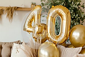 Happy 40th birthday. Gold helium 40 birthday balloons at a celebration event