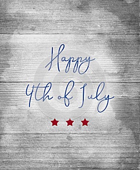 Happy 4th of July sign in blue letters with red stars on wood background