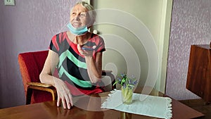 Happy 70s grandmother hold smartphone record audio message talking on gadget at home