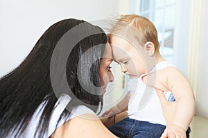 Happy 8 month old baby boy with mother