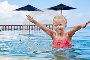 Happy active child have fun in infinity swimming pool