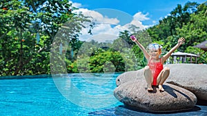 Happy active child have fun in infinity swimming pool