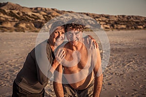 Happy active and healthy mature couple having fun on the beach enjoying outdoors lifestyle