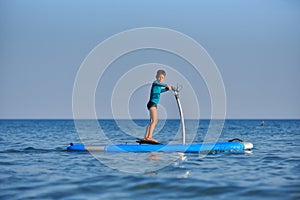 Happy active kid on a Hobie Stand Up Paddle board