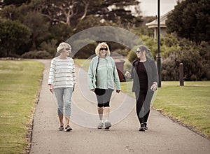 Happy active senior citizen women walking and training together in healthy retirement lifestyle