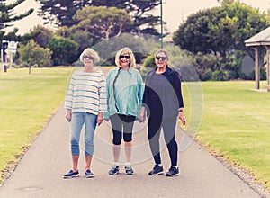 Happy active senior citizen women walking and training together in healthy retirement lifestyle