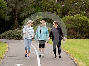 Happy active senior citizen women walking and training together in healthy retirement lifestyle photo