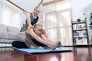 Happy active senior couple in sportswear doing yoga. Clout