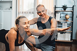 Happy active senior couple in sportswear doing yoga. Clout