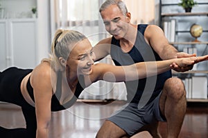 Happy active senior couple in sportswear doing yoga. Clout