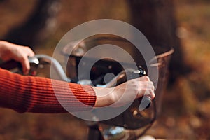 Happy active young woman riding bicycle in autumn park