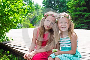 Happy adorable little girls enjoying warm summer