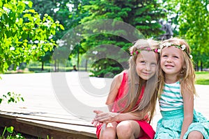 Happy adorable little girls enjoying warm summer