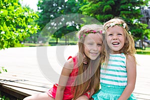 Happy adorable little girls enjoying warm summer