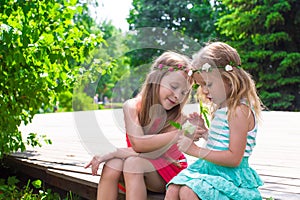 Happy adorable little girls enjoying warm summer