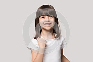 Happy adorable little preschool girl making yes gesture.