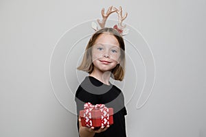 Happy adorble kid taking red present box on white background