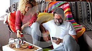 Happy adult caucasian couple at home enjoy breakfast together - autumn season and indoor leisure activity for man and woman in the